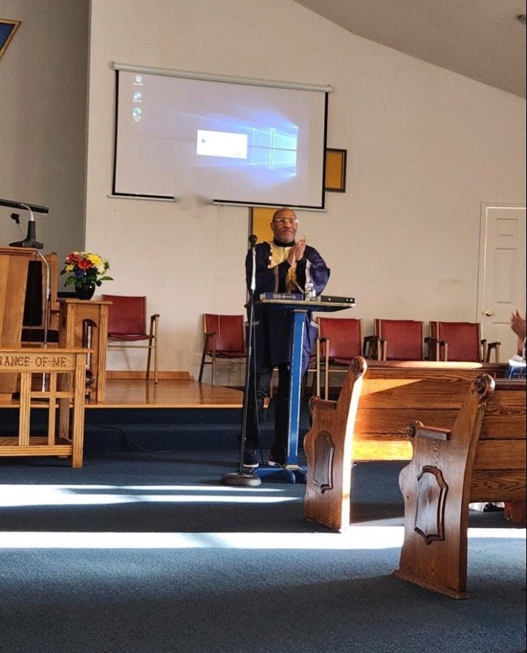 A minister preaching from the pulpit in the First Baptist Church sanctuary