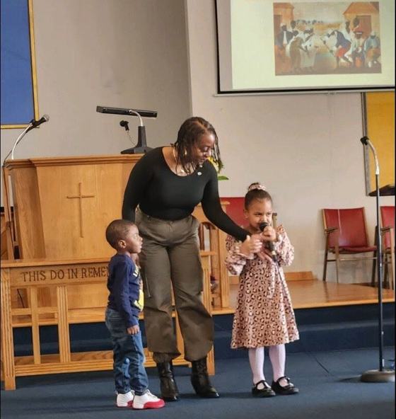 Karen with her grandchildren at the front of the sanctuary