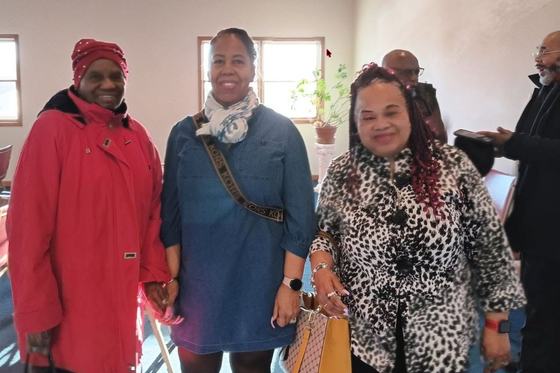 Ladies of First Baptist Church smiling together inside the church