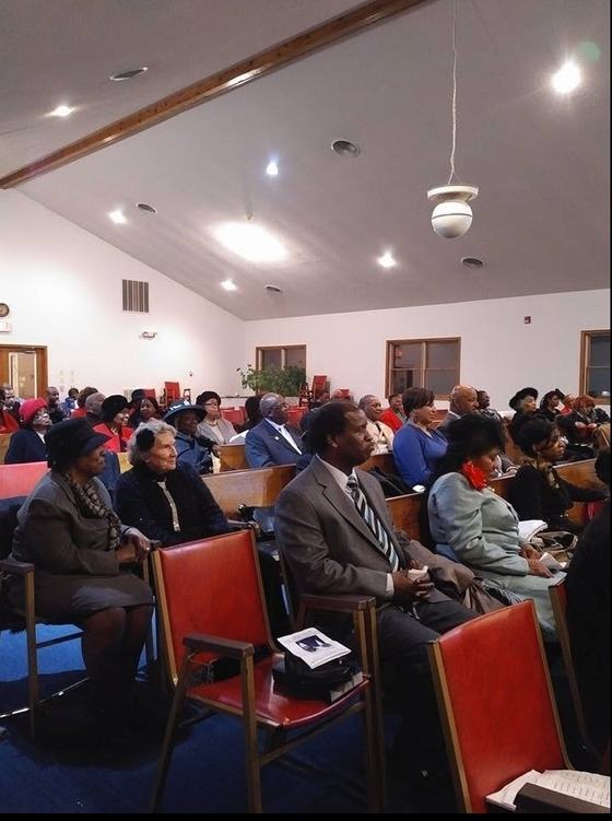 A full sanctuary of worshipers seated during a church service