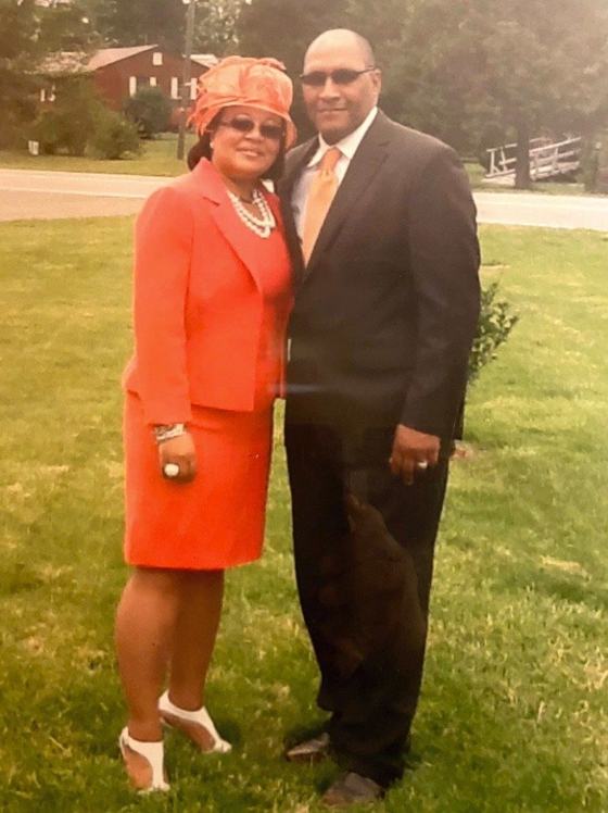 Pastor Paul L. Weather, Sr. and First Lady Weather standing together outdoors on the church grounds